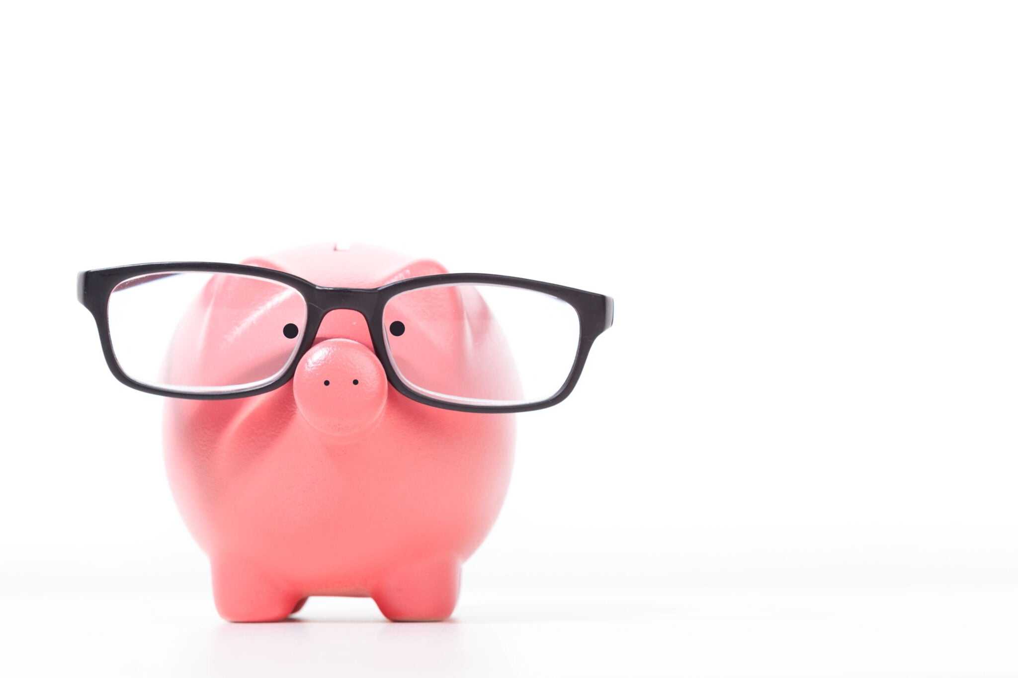 Pink piggy bank wearing black eyeglasses